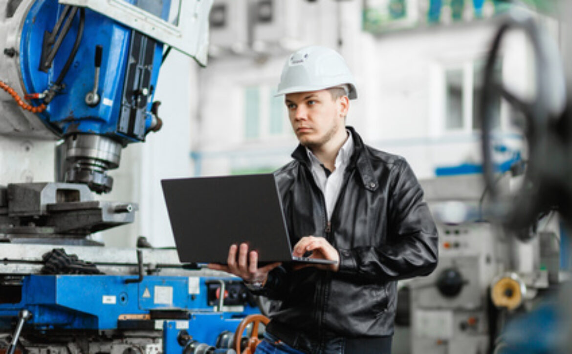 young engineer with laptop in hands