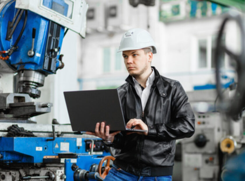 young engineer with laptop in hands