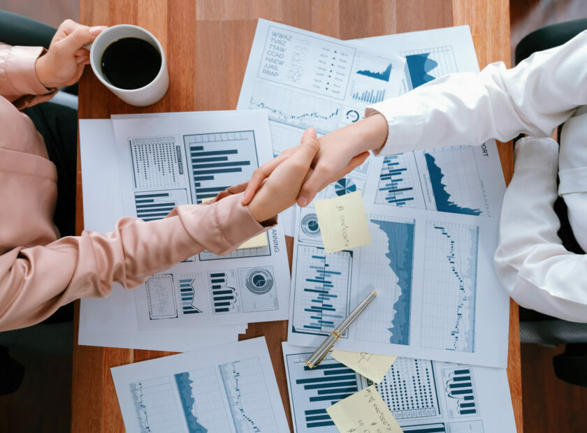 Top view asian businesswomen handshake over desk. Enthusiastic